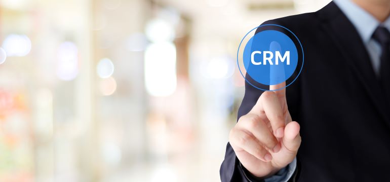 Man in suit clicking a virtual CRM button