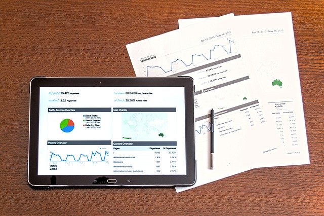 Papers and graphs on a tablet, symbolizing different data types.