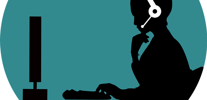 An illustration of a woman with headphones in front of a computer.