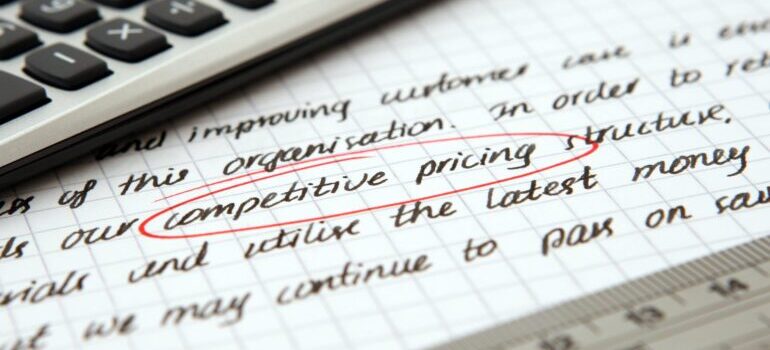 A close-up of a notebook where "competitive pricing" is circled in red.