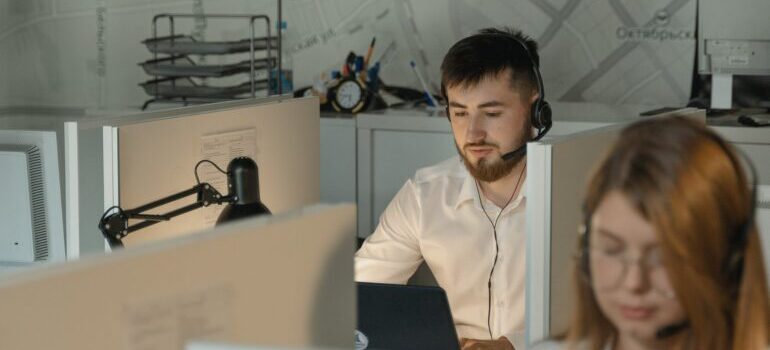 A man in a white shirt working at a call center.