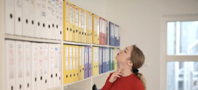 Woman looking at document file folders.