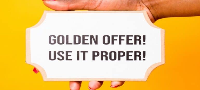 A hand holding a sign that says "Golden offer! Use it proper!"