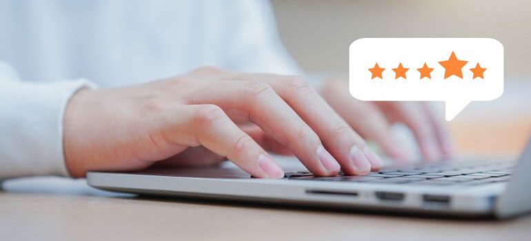 Person typing on laptop keyboard, with a rating star cloud above it.
