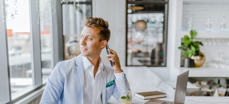 A person in professional attire talking on the phone.