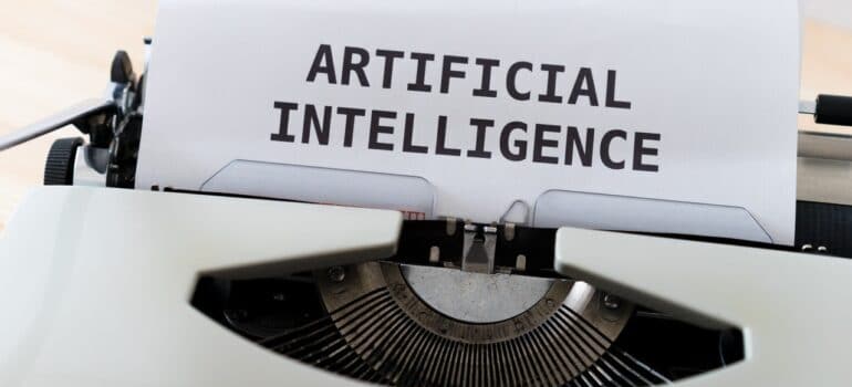 A typewriter with a piece of paper saying "Artificial intelligence.".