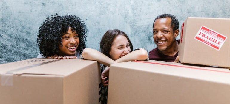 Movers smiling with customers, showing the benefit from conversational CRM.