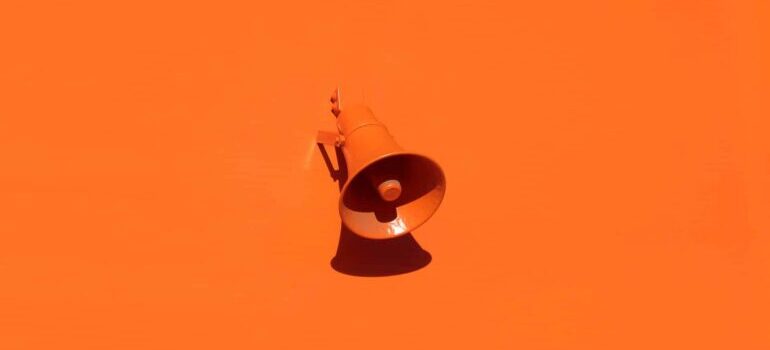 An orange megaphone on an orange background. 