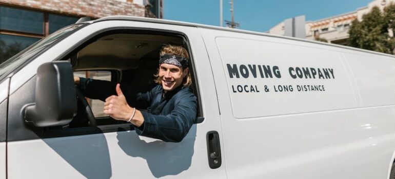 Movers giving a thumbs up showing what happens when you know how do moving quotes really work.