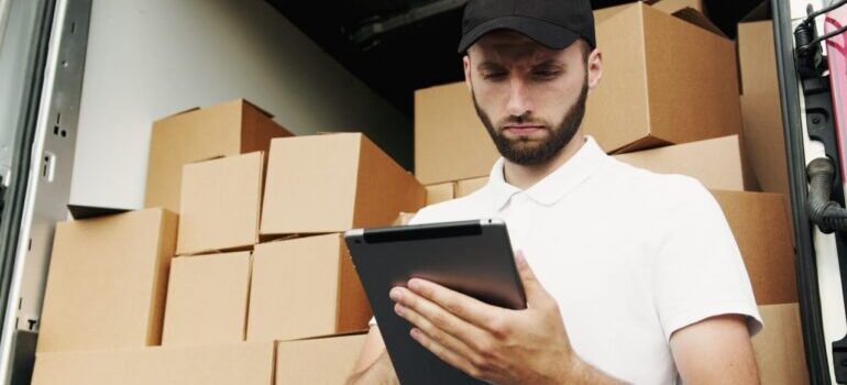 A person looking at an inventory list on a tablet.